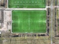 Soccer field form above, people playing sports, leisure and fitness health activities. Green pitch playing field. Aerial Royalty Free Stock Photo