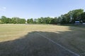 Soccer field with goals, trees and blue sky