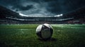 A soccer field with green grass, soccer ball lying on the field, rain coming down