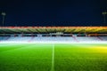 soccer field at night with brightly lit stadium stands and seats Royalty Free Stock Photo