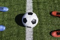 Soccer football background. Soccer ball and two pair of football sports shoes on artificial turf soccer field with Royalty Free Stock Photo