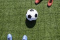 Soccer football background. Soccer ball and two players standing on artificial turf soccer field with shadow from Royalty Free Stock Photo