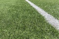 Soccer football background. Green synthetic artificial grass soccer sports field with white stripe line Royalty Free Stock Photo