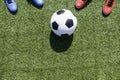 Soccer football background. Soccer ball and two pair of football sports shoes on artificial turf soccer field with Royalty Free Stock Photo