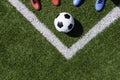 Soccer football background. Soccer ball and two pair of football sports shoes on artificial turf soccer field. Top view Royalty Free Stock Photo