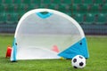 Soccer Football Ball and Soccer Goal For Children. Sports Soccer Equipment on Grass Stadium Venue Royalty Free Stock Photo