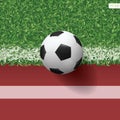 Soccer football ball on green grass of soccer field with running track for sports background. Vector Royalty Free Stock Photo