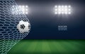 Soccer football ball in soccer goal with soccer field stadium background. Royalty Free Stock Photo