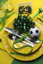 Soccer football celebration party table settings in yellow and green - vertical.