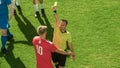 Soccer Football Championship Match: Referee Sees Foul, Gives Signal and Shows Yellow Card, Players Royalty Free Stock Photo