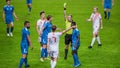 Soccer Football Championship Match: Referee Sees Foul, Gives Signal and Yellow Card, Players Circle Royalty Free Stock Photo