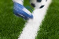 Soccer Football Kick. Footballer Kicking Ball on the Field. Close-up of soccer ball and footballers foot in motion Royalty Free Stock Photo