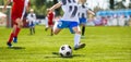 Soccer Football Kick. Young Player Kicking Soccer Ball. Footballers Running the Ball Royalty Free Stock Photo