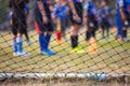Soccer or football net background, view from behind the goal with blurred football player Royalty Free Stock Photo