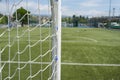 Soccer or football net background, view from behind the goal with blurred stadium and field pitch Royalty Free Stock Photo