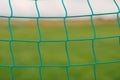 Soccer football net background wallpaper over green grass and blurry stadium behind Royalty Free Stock Photo