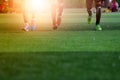 The soccer football players at the stadium with sunset. Royalty Free Stock Photo