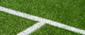 Soccer football sport background. Green synthetic artificial grass soccer sports field with white corner stripe line Royalty Free Stock Photo