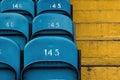 Soccer football stadium seats in blue with yellow stairs. Royalty Free Stock Photo