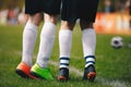 Soccer free kick wall - close up of players legs. Two young football players standing in wall during free kick