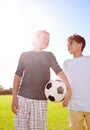 Soccer, friends and playing with ball on field, support and smile for sports game on grass. Boys, children and Royalty Free Stock Photo