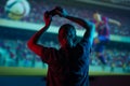 Soccer game, girl gamer playing a game in football headphones on a big screen, with bright light and a dark room. Gameplay, Royalty Free Stock Photo