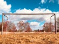 Soccer goal on countryside, low angle view of rural soccer field Royalty Free Stock Photo