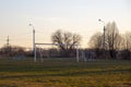 Soccer goal on an empty field in the evening sun