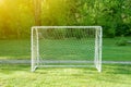 Soccer goal with soccer field green grass sunny day. Royalty Free Stock Photo