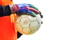 Soccer goalkeeper holding old soccer ball with gloves.. Royalty Free Stock Photo