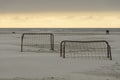 Soccer goals on a beach at sunset