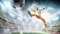 Soccer kick. A soccer player kicks the ball in air fashion. Professional soccer player in action. Stadium with Royalty Free Stock Photo