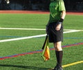 Soccer linesman official on the sideline holding a flag Royalty Free Stock Photo