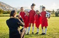 Soccer, photograph and sports coach with a girl team posing for a picture outdoor on a football field for fitness or