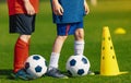 Soccer physical education lesson. Children training football on schools field