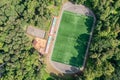Soccer pitch with amateur football players playing the game in the city park at sunny summer day. aerial view Royalty Free Stock Photo