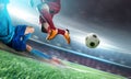 Soccer player in action kick ball at stadium. Royalty Free Stock Photo