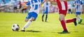 Soccer Player Action On Stadium. Youth Football Tournament Game. Young Boys Running and Kicking Soccer Ball on Green Soccer Pitch Royalty Free Stock Photo