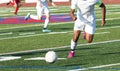 Soccer player chasing the ball down the field Royalty Free Stock Photo