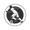 Soccer player dribbling with the ball, side view. Black vector football sports logo template with a soccer player on the round Royalty Free Stock Photo