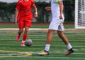 Soccer player dribbling the ball upfield heading toward a defender Royalty Free Stock Photo