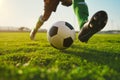 A soccer player dribbling and kicking a ball on a field Royalty Free Stock Photo