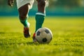 A soccer player dribbling and kicking a ball on a field Royalty Free Stock Photo