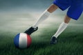 Soccer player exercises to kick a ball at field Royalty Free Stock Photo