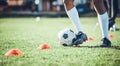 Soccer player, feet and ball with training cone on a field for sports game and fitness. Legs or shoes of male football Royalty Free Stock Photo