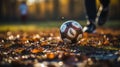 Soccer player feet kicking ball on dirty field