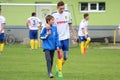 Soccer Player Interacts with Young Fan on Field