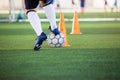 Soccer player jogging and control ball around cone markers for soccer training Royalty Free Stock Photo