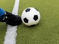 Soccer player kick the ball on football stadium field Royalty Free Stock Photo