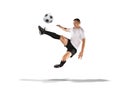 Soccer player kicking the ball in the air isolated on white